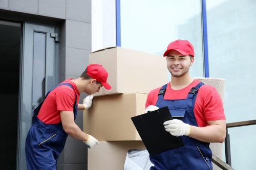 Removalists carrying furniture from a flat in Brixton