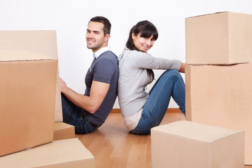 Preparing boxes and furniture for a moving truck in Brixton