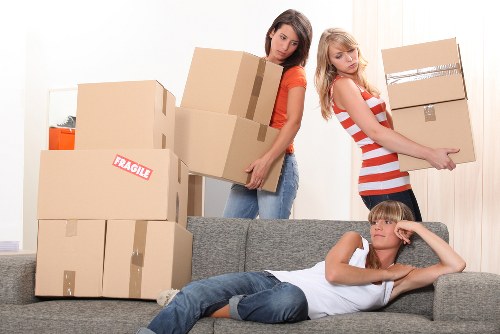 Moving crew organising a Brixton flat relocation with careful loading