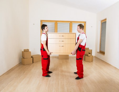 Team handling boxes and sofas during a Brixton home move